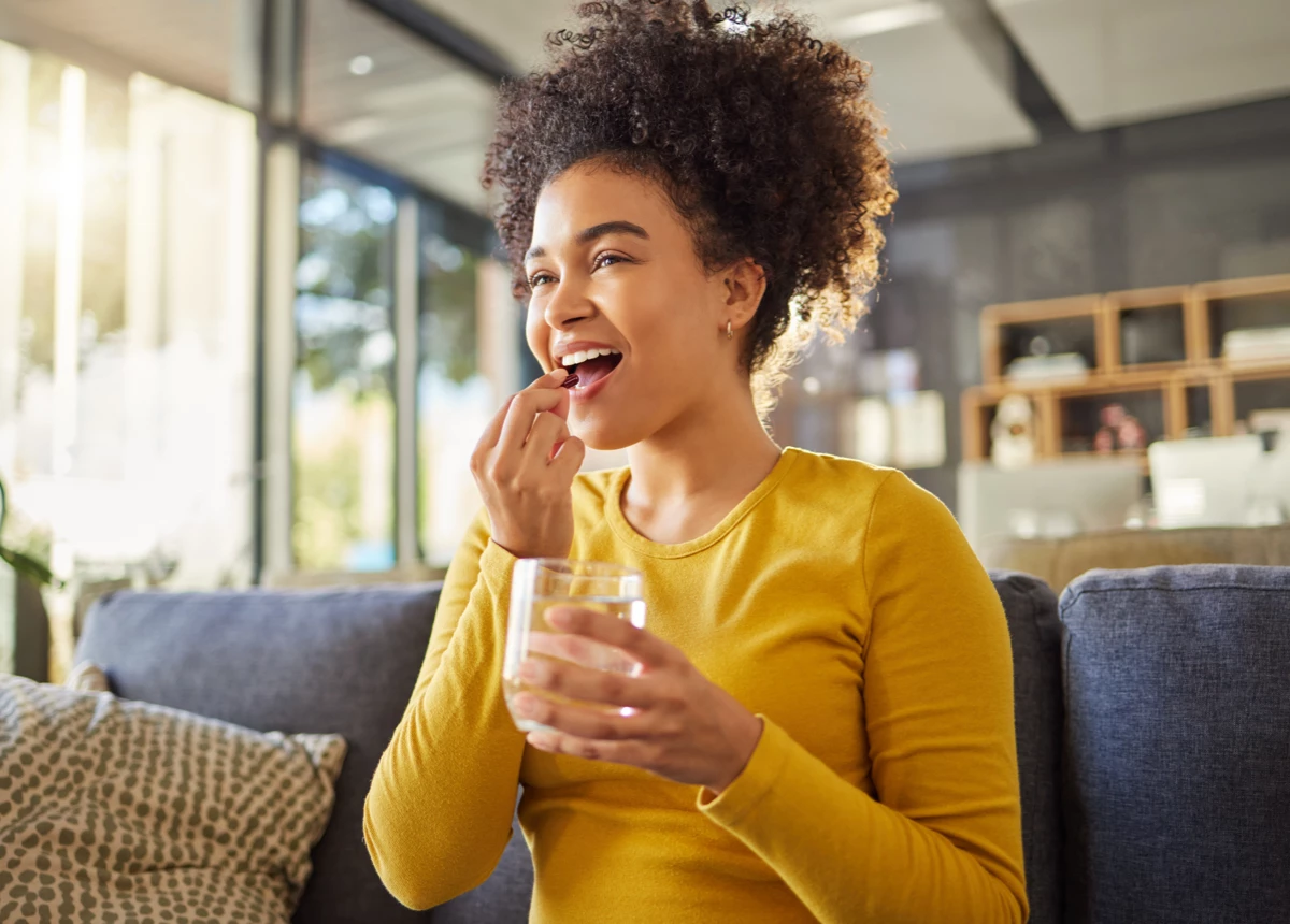 Woman taking Cystex pill
